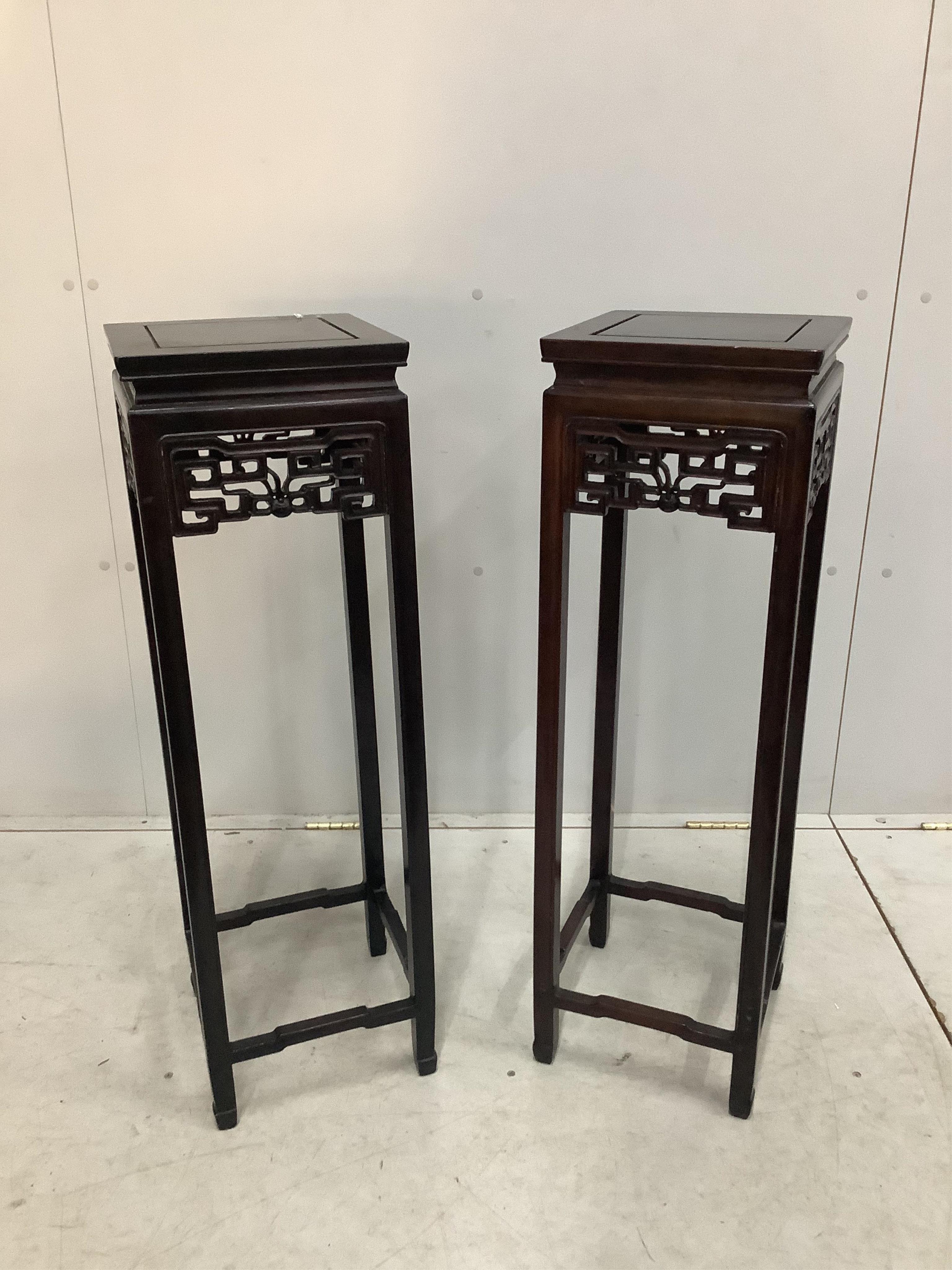 A pair of Chinese square hardwood vase stands, width 28cm, height 92cm. Condition - fair